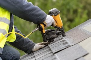 unrecognizable,roofer,worker,in,uniform,work,wear,using,air,or unrecognizable,roofer,worker,in,uniform,work,wear,using,air,or